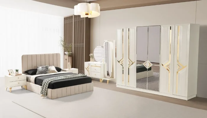 Lüks krem Venüs yatak odası takımı, yatak, komodinler, dresuar ve büyük gardırop ile birlikte şık bir odada.